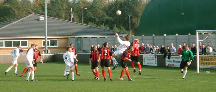 Tomkins jumps for a corner